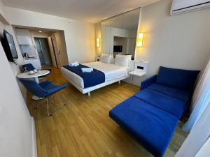 a hotel room with a bed and a couch at Orbi City Sea View in Batumi