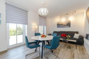 a living room with a table and chairs and a couch at StrandEins Whg_ 6 _Baltica_ in Rerik