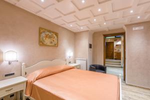 a bedroom with a bed with an orange bedspread at B&B La Casa Nel Giardino in Piano di Sorrento