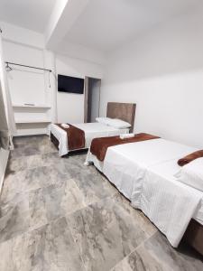 Voodi või voodid majutusasutuse Hotel Maranta toas