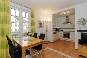 a kitchen and dining room with a table and chairs at Villa Antonia Whg_ 7 in Rerik