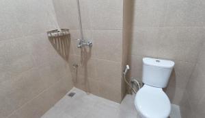 a bathroom with a toilet and a shower stall at OYO 1030 Ai Hotel in Manila