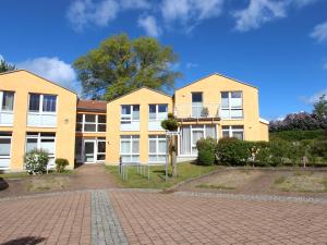 a row of houses on a brick road at _Residenz Meeresblick_ Haus B _ Wh in Rerik