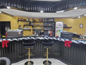 a bar in a restaurant with red bows at Hotel Annis M&P in Dortmund