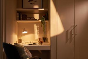 a room with a desk with a lamp and a chair at 22 Eikehoff Apartment in Stellenbosch