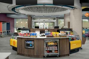 a food counter in a restaurant with food at Tru By Hilton North Richland Hills Dfw West in North Richland Hills