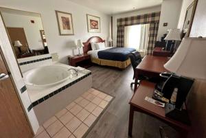 a hotel room with a bed and a bath tub at Wingate by Wyndham Eagle Vail Valley in Eagle