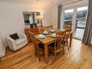 a kitchen and dining room with a table and chairs at Curlew in Milford Haven