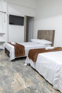 Voodi või voodid majutusasutuse Hotel Maranta toas