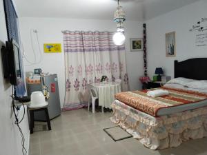 a bedroom with a bed and a table in it at M-J Room Rental in Alcoy