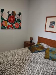 a bedroom with a bed and a picture on the wall at Casa do Adro- Douro in Peso da Régua