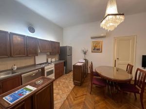 a kitchen with a table and a dining room at Apartment Croatia in Zagreb