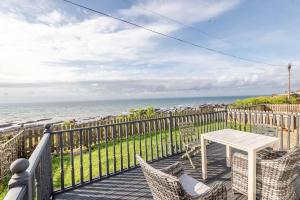 a balcony with a table and chairs and the ocean at Sea View - Stunning views from patio - Sleeps 4 in Pittenweem