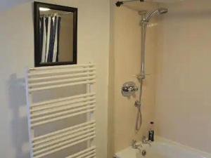 a bathroom with a shower and a sink and a mirror at Captivating Tudor 2 Bedroom Apartment in Ipswich in Ipswich