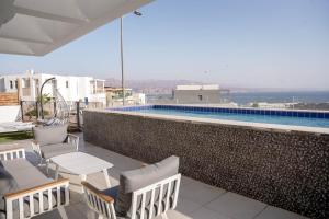 a balcony with chairs and a swimming pool at YalaRent Mountainside Luxury apartments with Private Pool in Eilat