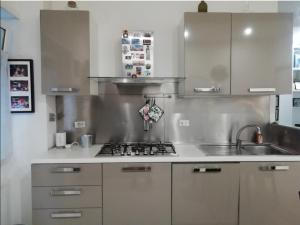 a kitchen with a sink and a stove top oven at Comfortable apartment in a strategic position in Rome