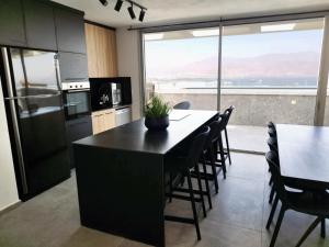 a kitchen with a table and chairs and a large window at YalaRent Mountainside Luxury apartments with Private Pool in Eilat