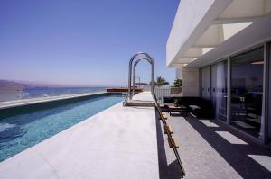 a swimming pool on the side of a house at YalaRent Mountainside Luxury apartments with Private Pool in Eilat