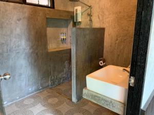 a bathroom with a sink and a bath tub at Chill Villa in Ban Pak Nam Pran
