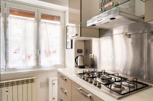 a kitchen with a stove top oven in a kitchen at Comfortable apartment in a strategic position in Rome