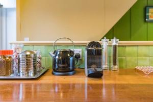 a coffeemaker sitting on top of a kitchen counter at Folkestone Terrace - quirky vibe holiday home in Kent