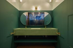 a bathroom with a sink and a mirror at Konjaku-So Tengachaya Tea and Relax in Osaka