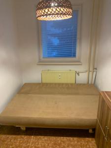 a bed in a room with a window at Lovely room for 2 persons in 3 room flat in Košice