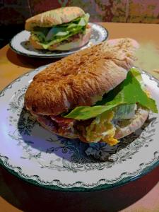 a sandwich on a plate on a table at Open Space Apartment in Belgrade