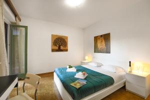 a bedroom with a bed and a table and a desk at Santiago Home - Happy Rentals in Lugano