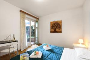 um quarto com uma cama, uma secretária e uma janela em Santiago Home em Lugano
