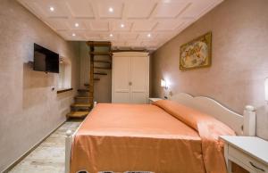 a bedroom with a bed with an orange blanket at B&B La Casa Nel Giardino in Piano di Sorrento