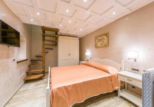 a bedroom with a bed and a spiral staircase at B&B La Casa Nel Giardino in Piano di Sorrento
