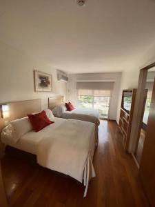 a bedroom with two beds in a room at Apart Hotel Rio Grande in Rosario