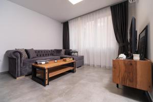 a living room with a couch and a coffee table at Chic 1BR Apartment with Balcony in Plovdiv in Plovdiv