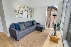 a living room with a gray couch and a window at Host & Stay - The Skandi Hideaway in Liverpool