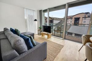 a living room with a couch and a large window at Host & Stay - The Skandi Hideaway in Liverpool