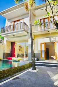 a house with a swimming pool in front of it at Private 3- bedroom Villa with pool. in Kuta