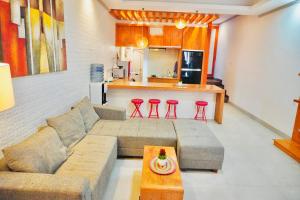 a living room with a couch and a kitchen at Private 3- bedroom Villa with pool. in Kuta