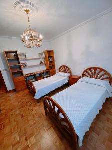 A bed or beds in a room at Casa Paradela Sanxenxo