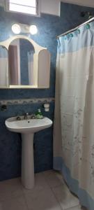 a bathroom with a sink and a mirror at Departamento zona terminal/parque in Dolores