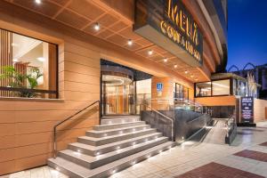 a building with stairs in front of a store at Melia Costa del Sol in Torremolinos