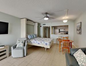 a bedroom with a bed and a table and chairs at Ocean Sands 505 in St. Pete Beach
