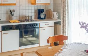 a kitchen with a stove and a counter top at Beautiful Apartment In Wagrain With 2 Bedrooms And Wifi in Wagrain