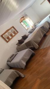 a room with several pillows lined up against a wall at Hotel Fazenda Chiminelli in Cachoeiras de Macacu