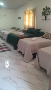 een groep bedden in een kamer bij Hotel Fazenda Chiminelli in Cachoeiras de Macacu