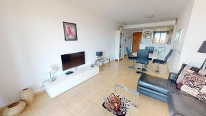 a living room with a couch and a flat screen tv at Casa Espliego V-A Murcia Holiday Rentals Property in Torre-Pacheco