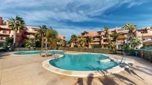 a swimming pool in front of a apartment complex at Casa Espliego V-A Murcia Holiday Rentals Property in Torre-Pacheco