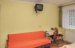 a living room with a red couch and a table at Beautiful Apartment In Wagrain With 2 Bedrooms And Wifi in Wagrain