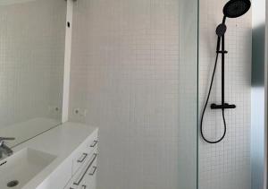 a bathroom with a shower with a shower head at Motel by Maier Feldkirch - kontaktloser Check-in in Feldkirch