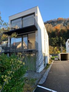 a house with a balcony on the side of it at Motel by Maier Feldkirch - kontaktloser Check-in in Feldkirch